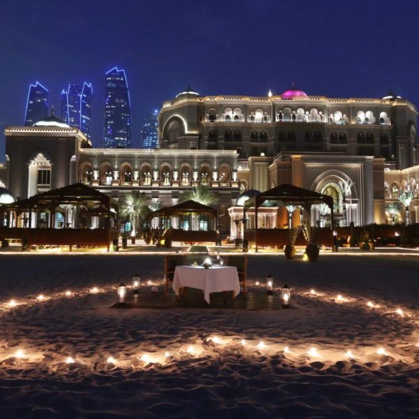 a building with a heart shaped table and candles in the middle