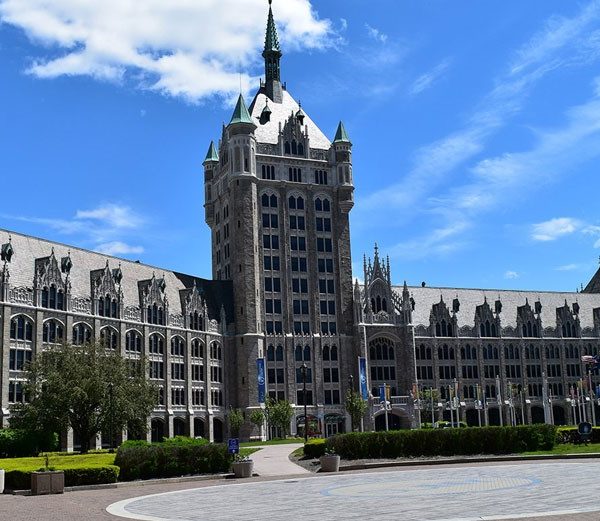 a large building with many windows with New Town Hall in the background