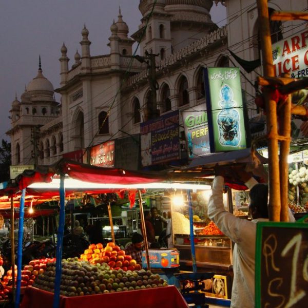 a man standing at a fruit stand