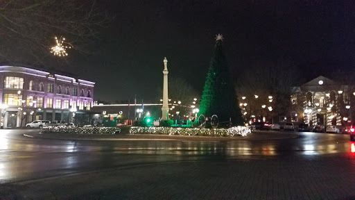 a christmas tree and a monument in the middle of a street